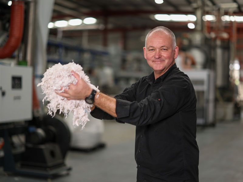 BlockTexx co-founder Graham Ross holding shredded items