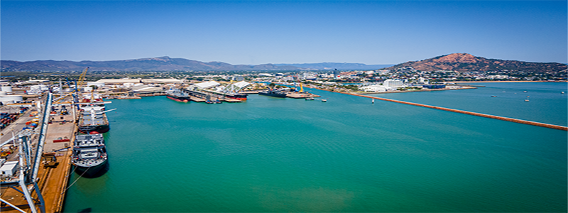 Aerial image of Townsville Port on a sunny day overlooking blue water with cargo ships around the port.